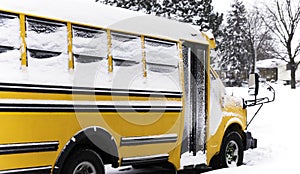 School bus parked in a residential neighborhood during a snow da