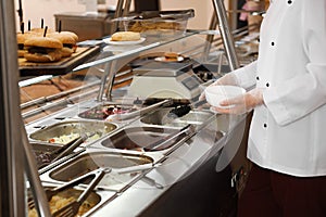 School canteen worker at serving line photo