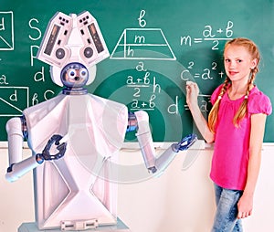 School child and ai robot writting on blackboard in classroom.