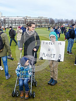 school child at anti climate change protest in The Hague with banners walking through the city