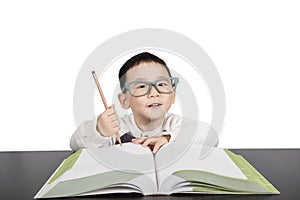 School child boy in glasses studying book