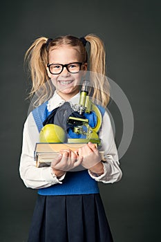 School Child Girl with Books and Microscope, Blackboard Background