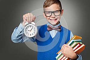 School Child in Glasses with Alarm Clock and Books, Smart Kid