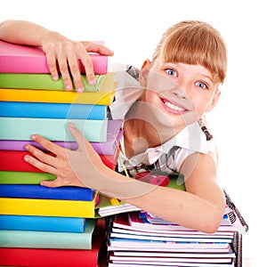 School child holding stack of books.