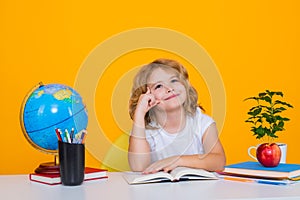School child portrait isolated on yellow studio background. Kid boy from elementary school. Pupil go study. Clever