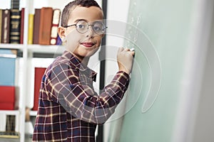 School child writing blackboard