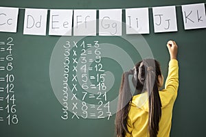 School child writing blackboard