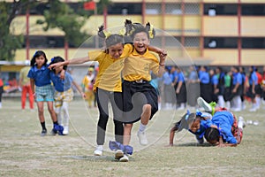 School children compete in three legged race