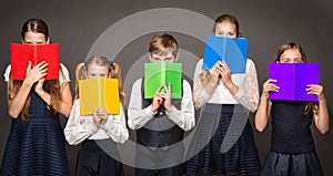 School Children Cover Face by Book. Kids Eyes Looking at Camera hiding by Rainbow Color Books. Group of Student Learning Reading