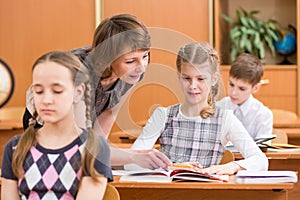 School children at lesson. Teacher monitoring..