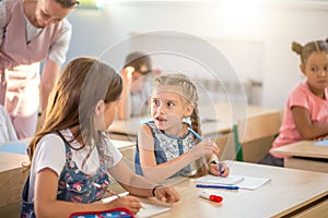 School children are participating actively in class. Education, homework concept