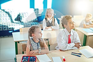 School children participating actively in class. Education, learning, high school