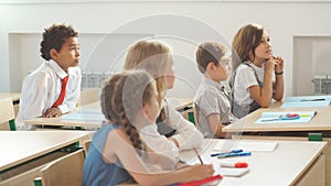 School children participating actively in class. Education, learning, high school