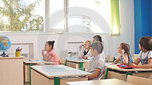 School children participating actively in class. Education, learning, high school