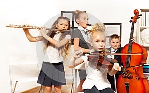 School children play musical instruments together