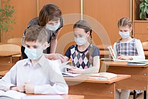 School children with protection masks against flu virus at lesson