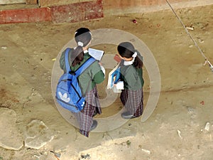 School children reading on the way to school to prepare for examinations