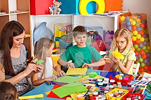 School children with scissors in kids hands cutting paper .