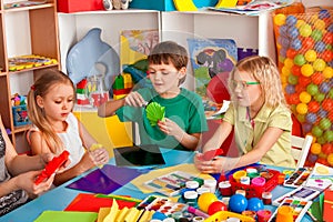 School children with scissors in kids hands cutting paper.