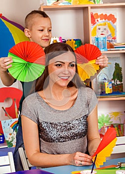 School children with scissors in kids hands cutting paper .