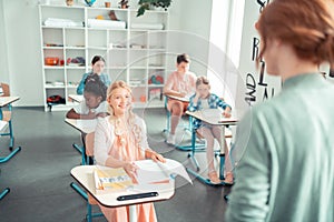 School children sitting at the lesson listening to the teacher.