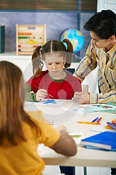 School children and teacher in art class