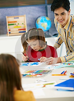 School children and teacher in art class