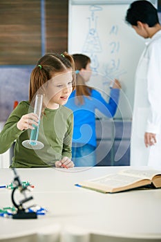 School children and teacher in science class