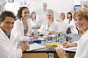 School children and their teacher in science class