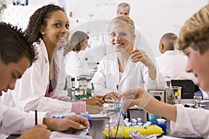 School children and their teacher in science class