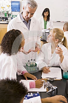 School children and their teacher in science class