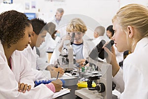 School children and their teacher in science class