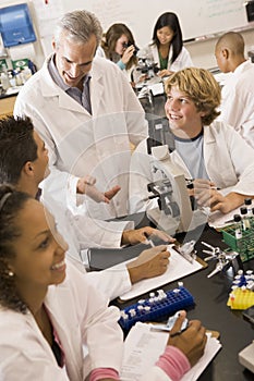 School children and their teacher in science class