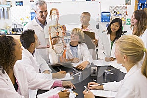 School children and their teacher in science class