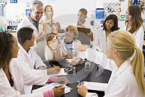 School children and their teacher in science class