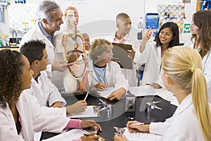 School children and their teacher in science class