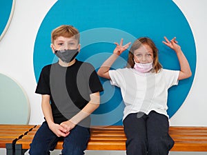 School children wearing face mask during corona virus and flu outbreak. Boy and girl going back to school after covid-19