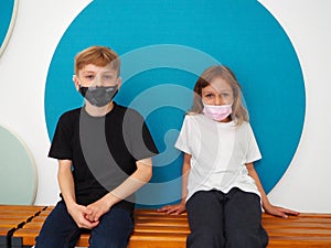 School children wearing face mask during corona virus and flu outbreak. Boy and girl going back to school after covid-19