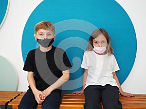 School children wearing face mask during corona virus and flu outbreak. Boy and girl going back to school after covid-19