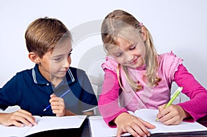 School children writing together