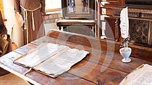 School class in ancient times. An old manuscript on a wooden desk for teaching reading and writing in a Catholic monastery in the