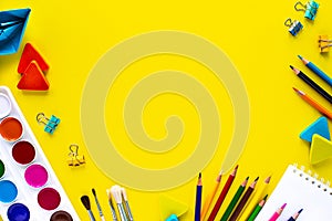School colorful stationery on yellow background with copyspace