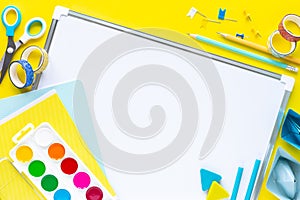 School colorful stationery on yellow background with copyspace