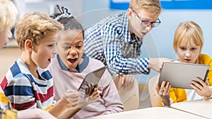 School Computer Science Class: Schoolchildren Use Digital Tablet Computers and Smartphones with