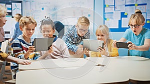 School Computer Science Class: Schoolchildren Use Digital Tablet Computers and Smartphones with