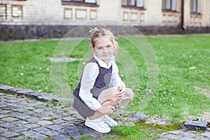 School concept. Back to school. A little girl holds a magnifying glass magnifier in her hands and examines insects. Botany. biol