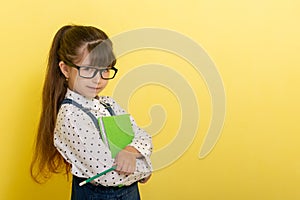 School concept. Back to School. Smart wunderkind in nerdy glasses and school uniform