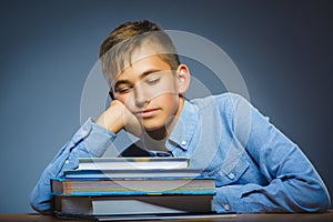 School concept. Closeup portrait boy asleep on pile of books