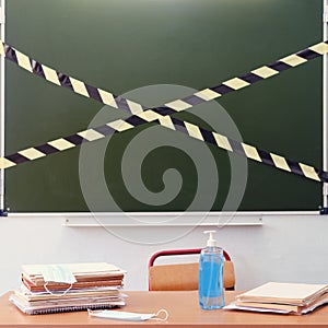 School desk with disinfectants and antibacterial soap. Class closed for isolation due to virus quarantine