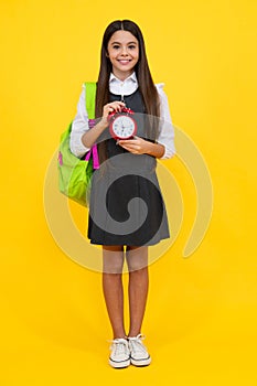 School and education concept. Back to school. Schoolchild, teenage student girl with clock alarm, time to study. Happy